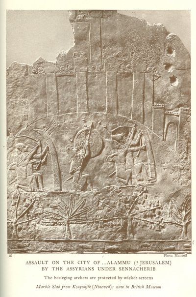 ASSAULT ON THE CITY OF . . .ALAMMU (? JERUSALEM) BY THE ASSYRIANS UNDER SENNACHERIB<br> The besieging archers are protected by wicker screens<br> <i>Marble Slab from Kouyunjik (Nineveh): now in British Museum</i>.<br> Photo. Mansell